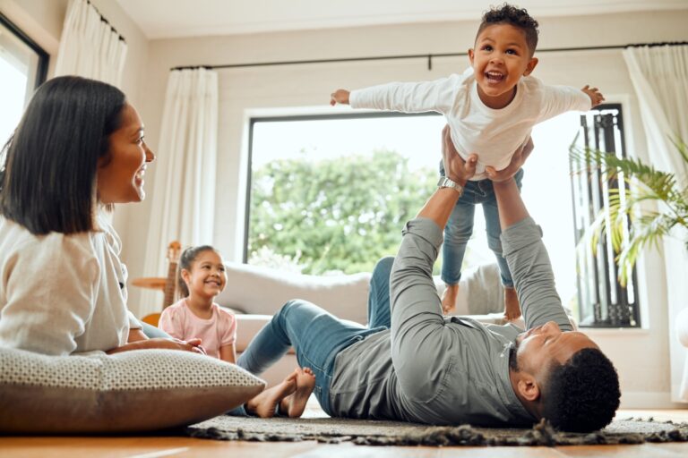 Family having fun. Dad holding up son. ATVM family travel