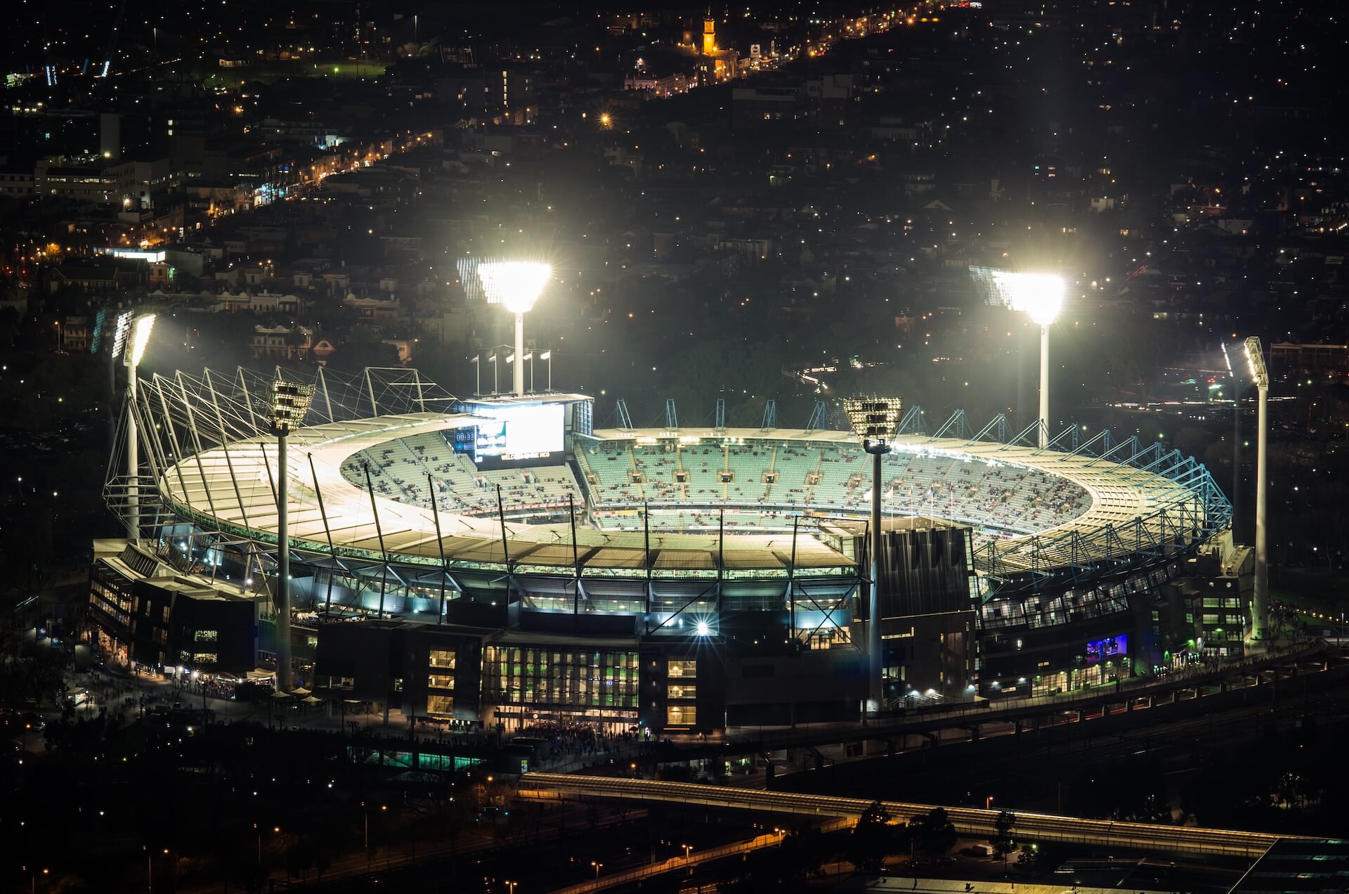 Melbourne Cricket Ground (MCG) at night from far away. A guide to Melbourne’s best sports grounds